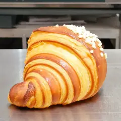 Un delizioso dolce tipico di Ischia, un croissant sfogliato e dorato, cosparso di perline di zucchero croccanti.
