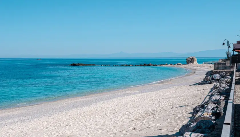 Spiaggia del Convento: sabbia chiara, mare azzurro cristallino, rocce e un faraglione solitario. Un angolo di paradiso.